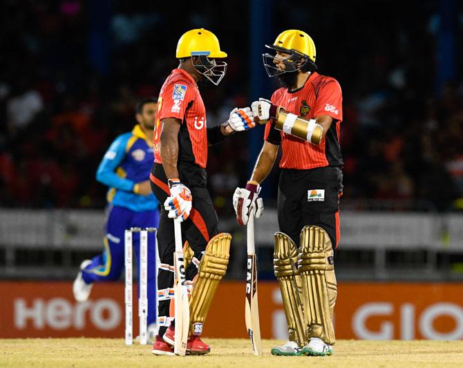 Dwayne Bravo (left) and Hashim Amla of Trinbago Knight Riders during Match 3 of the Caribbean Premier League between Trinbago Knight Riders and Tridents at Queen