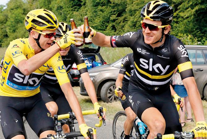 Overall leader Christopher Froome (left) and Geraint Thomas celebrate with beers at the start of the last stage of the Tour de France between Chantilly and Paris Champs-Elysees yesterday. 