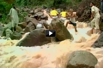 Watch Video: Locals help school children cross flood-water stream in J&K