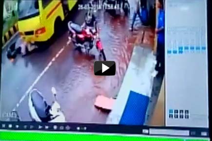 Watch Video: Miraculous escape for two on scooty dragged under bus 