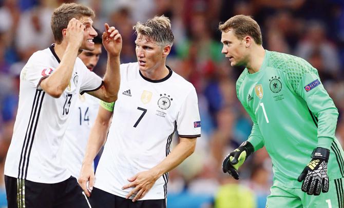 German striker Thomas Mueller (left) has an animated chat with goalkeeper Manuel Neuer while Bastian Schweinsteiger (centre) looks on during their Euro 2016 semi-final against France. Pic/Getty Images