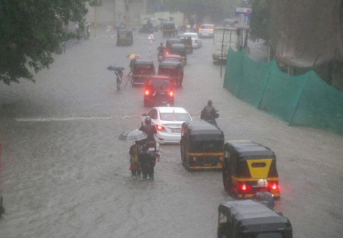 Vehicles plying through the flooded Mumbai roads