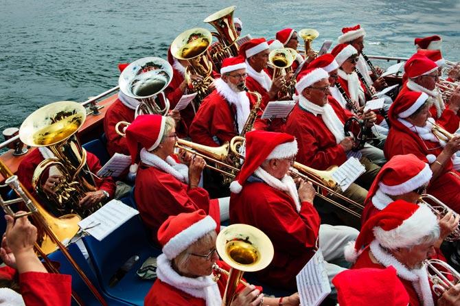 Santas from all over the world play in a band on board a boat as they gather on July 18, 2016 for the 59th World Santa Convention