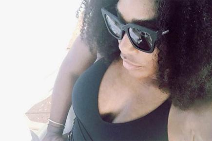 Serena Williams slams nipplegate, flaunts curves in black swimsuit