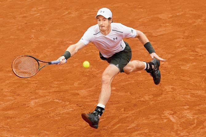Andy Murray returns to Stan Wawrinka (inset) during his French Open semi-final at Roland Garros in Paris yesterday. Murray won 6-4, 6-2, 4-6, 6-2. Pics/Getty Images