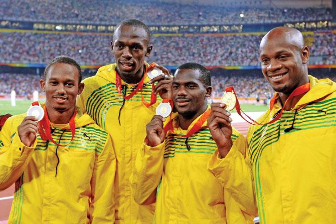 Michael Frater (extreme left), Bolt, Nesta Carter and Powell pose with their 2008 Beijing Olympic 4x100m relay gold medals. PIC/Getty Images