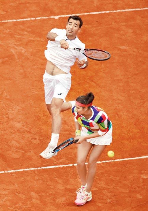 Sania Mirza ducks as partner Ivan Dodig returns during the French Open mixed doubles final in Paris yesterday