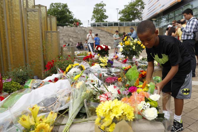 Mourners leave flowers at a memorial outside the Muhammad Ali Center following the boxing legend