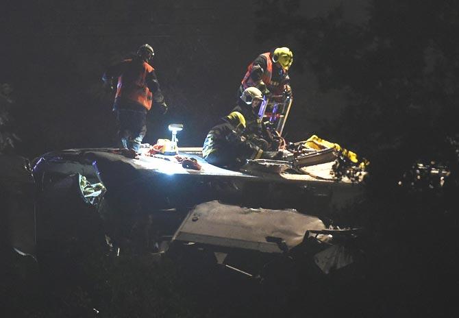 First-aid workers work on the roof of traveler
