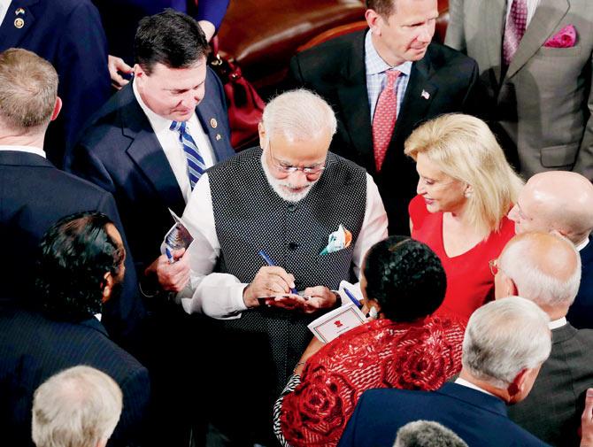 sign of the times: Prime Minister Modi signs autographs after addressing members of Congress at the US Capitol yesterday. Pic/PTI