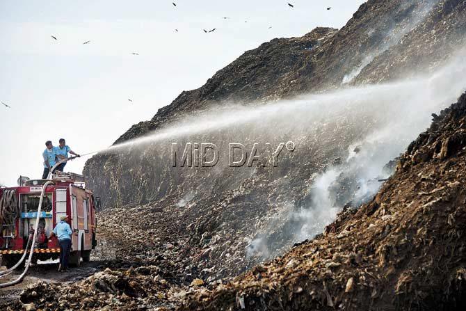 Fire brigade personnel try to douse the fire at the Aadharwadi dumping ground. PIC/Sameer Markande