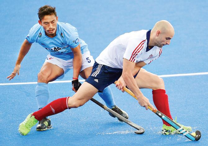 India’s Kothajit Khadangbam (left) and Nick Catlin of Great Britain tussle for the ball during the Champions Trophy match at Queen Elizabeth Olympic Park in London on Saturday. PIC/GETTY IMAGES