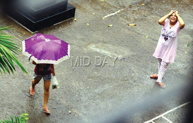 Locals in Sion enjoy the rains on Saturday. Pic/Atul Kamble