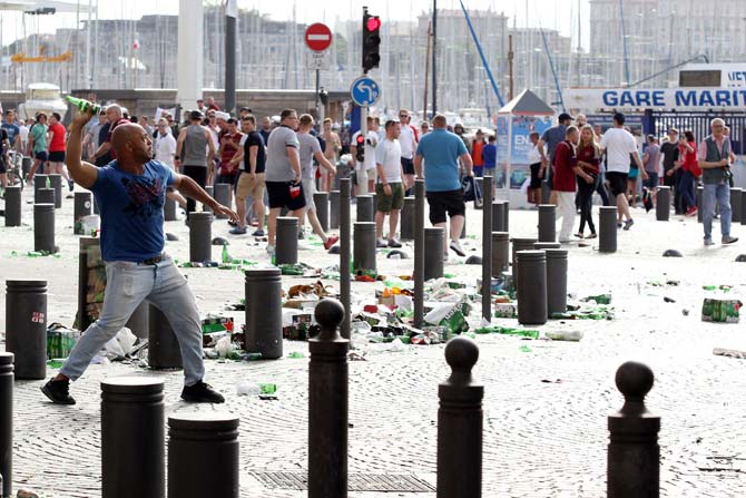 A man throws a beer can during street brawls ahead of the Euro 2016 football match England vs Russia. Pic/ AFP