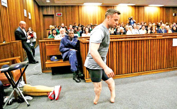 Oscar Pistorius walks across the courtroom without his prosthetic legs at the Pretoria High Court yesterday. Pic/AFP