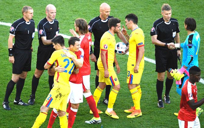 Swiss and Romanian players thank the match officials after a 1-1 draw following the Euro 2016 group A football match between Romania and Switzerland at the Parc des Princes stadium in Paris. Pic/AFP