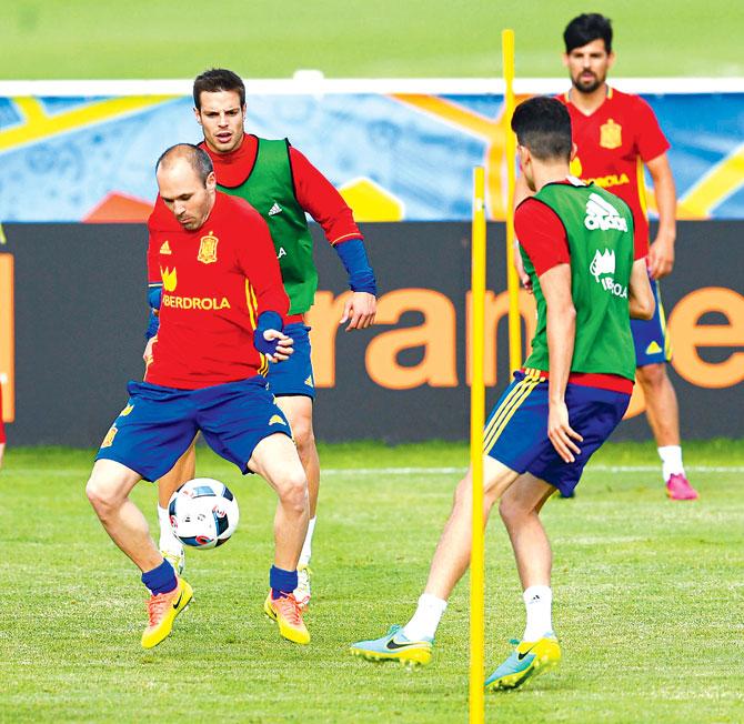Spain midfielder Andres Iniesta (left) tries to control the ball during a training session in La Rochelle, France. Pic/Getty Images