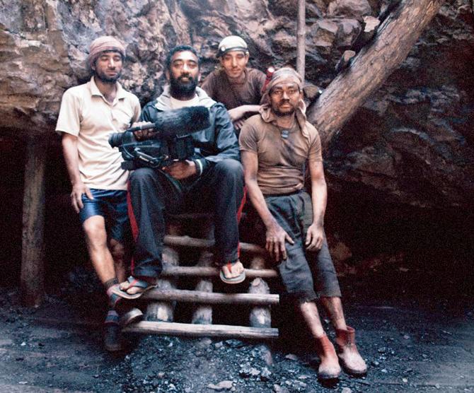 The director (centre) with the coal miners of East Jaintia Hills