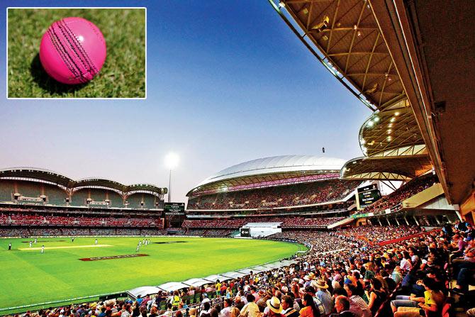 Spectators watch the day-night Test action between Australia and New Zealand at Adelaide last year. INSET: The pink ball. PICs/GETTY IMAGES