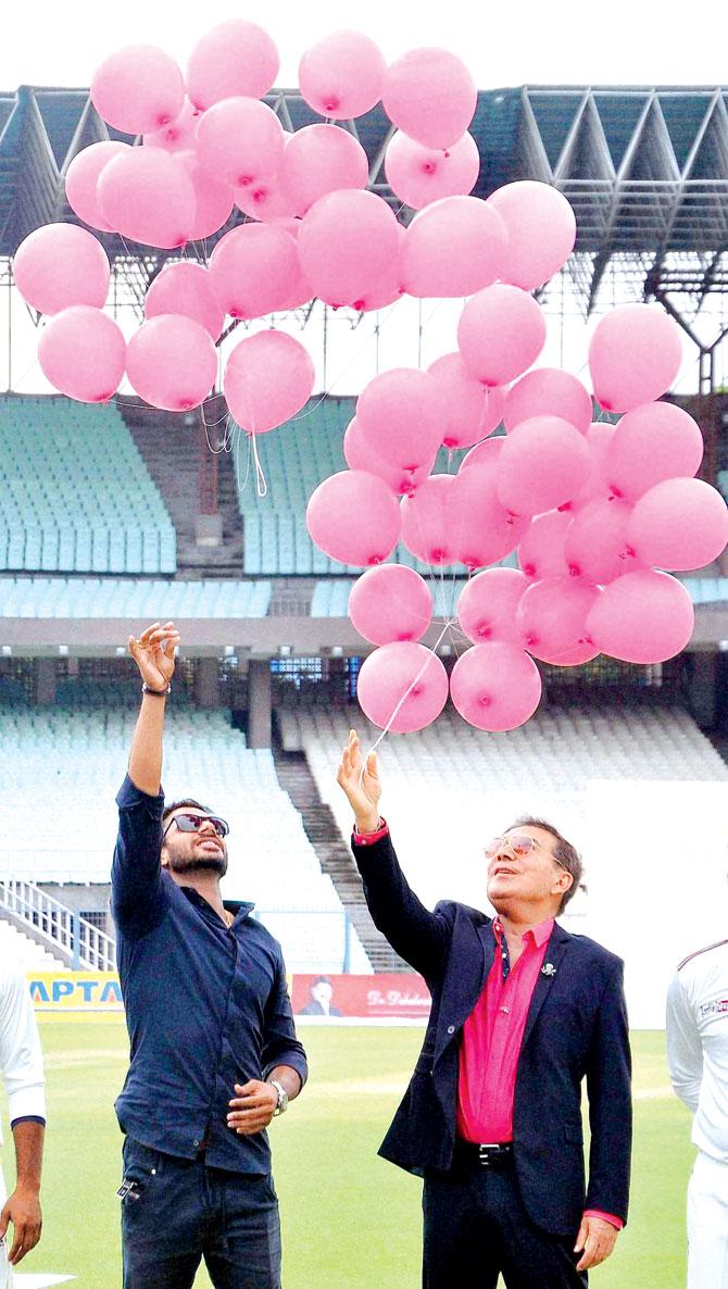 Arun Lal (right) & Manoj Tiwary release pink balloons prior to the pink-ball tie on Saturday. Pic/PTI
