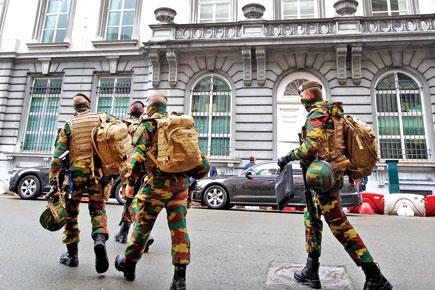 Belgium stages dozens of anti-terror raids, 12 held