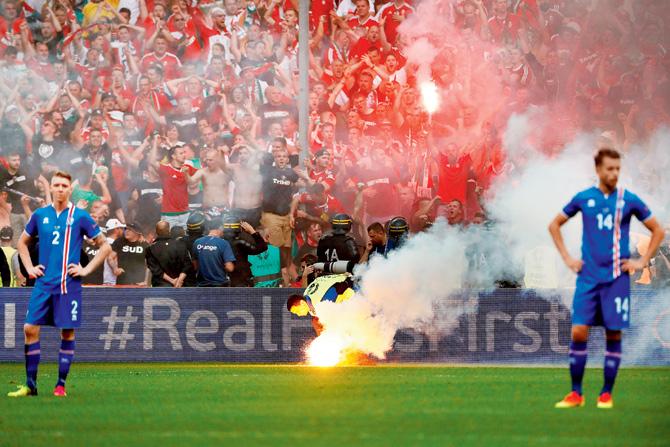 Hungary supporters throw flares on the pitch during the Euro 2016 match between Iceland and Hungary at Stade Velodrome in Marseille, France on Saturday. pic/AFP 