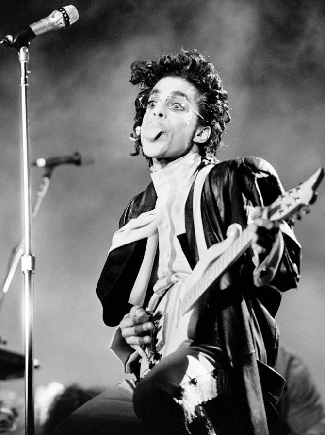 This black and white photo taken on June 15, 1987 shows musician Prince performing on stage during a concert at the Bercy venue in Paris. PIC/AFP