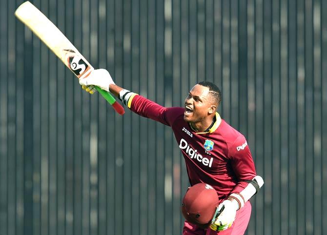 West Indies batsman Marlon Samuels celebrates after scoring his century (100 runs) during the 8th One Day International match of the Tri-nation Series between Australia and West Indies at the Kensington Oval stadium in Bridgetow. Pic/AFP