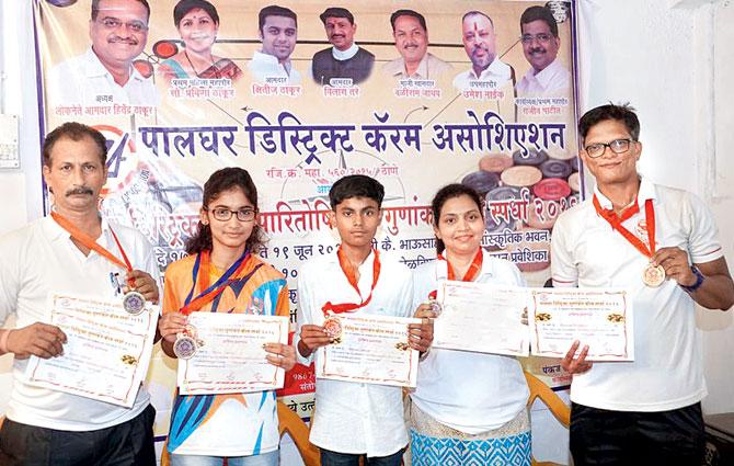 Individual winners of the first Palghar District carrom tournament pose with their medals and certificates