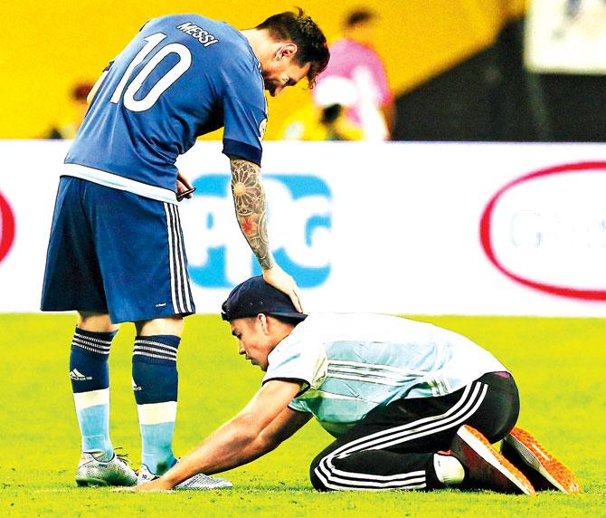A fan touches Lionel Messi
