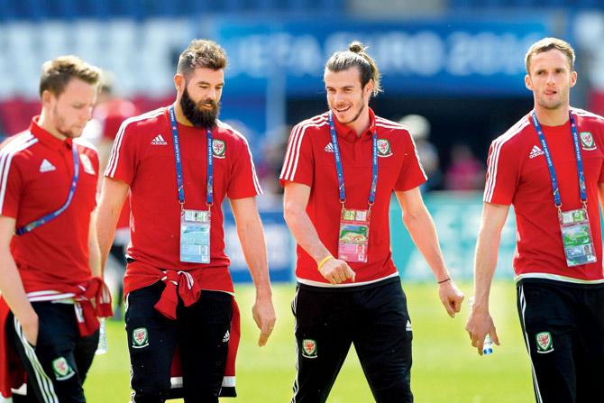 Wales players Chris Gunter (left) Joe Ledley, Gareth Bale and Andy King (right) share a joke ahead of an open media session in Paris. Pic/AFP