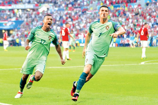 Portugal skipper Cristiano Ronaldo (right) celebrates a goal against Hungary with teammate Nani during their Euro 2016 encounter in Lyon, France on Wednesday. Pic/Getty Images