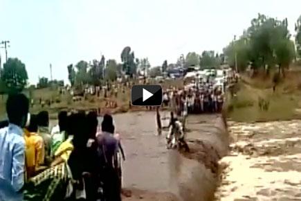 Watch video: Vehicle washes away as heavy rains lash MP