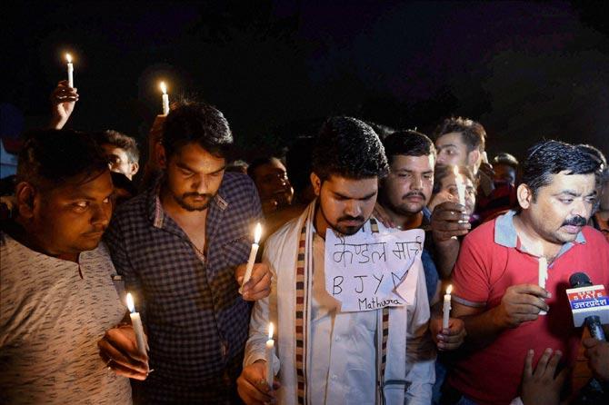 BJYM members holding a candle light march for the slain police men of Thursday