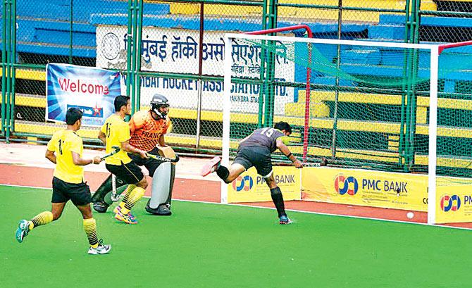 FCI and Mumbai Customs players vie for the ball during All India Gold Cup hockey championship in Churchgate, Mumbai yesterday