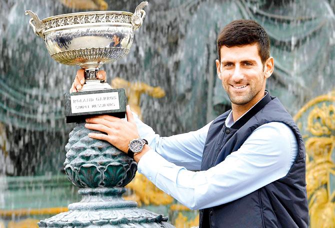The morning after: Novak Djokovic poses with the French Open trophy at Place de la Concorde in Paris yesterday. Pic/AFP