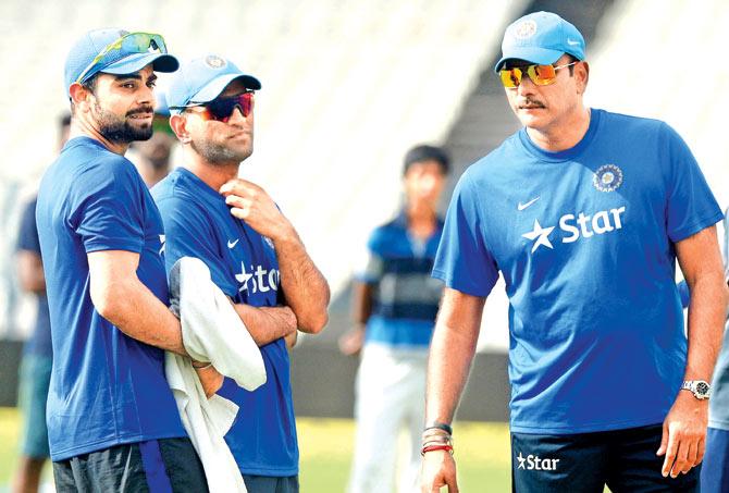 Then Team India director Ravi Shastri (right) with limited overs skipper Mahendra Singh Dhoni (centre) and Virat Kohli during a training session on the eve of the third Twenty20 international against South Africa at Eden Gardens in Kolkata last October. Pic/AFP