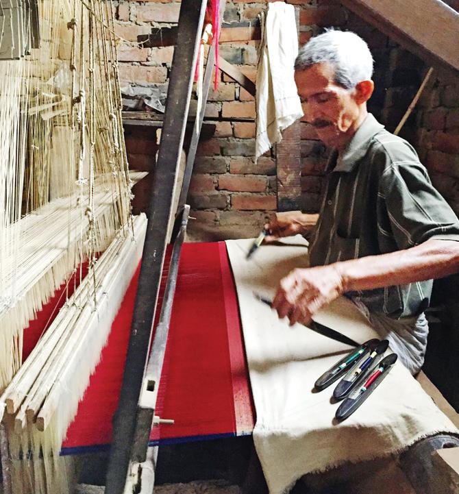 A weaver in Varanasi works on the brocade fabric for the shoe
