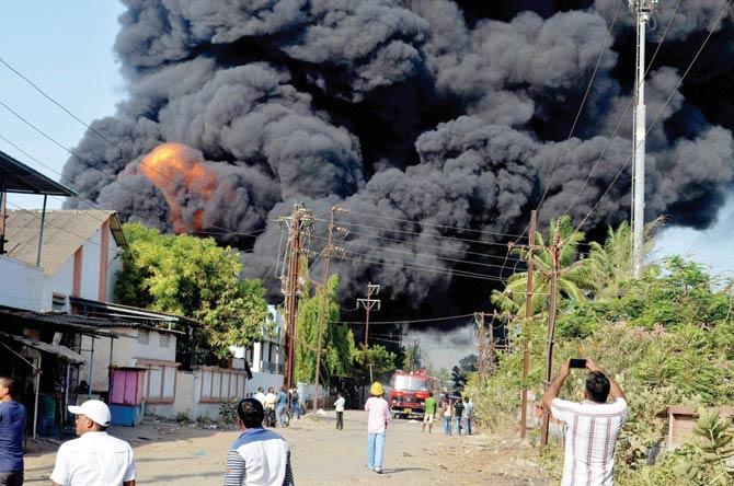 The blaze spread to some huts behind the industrial area. Pic/PTI