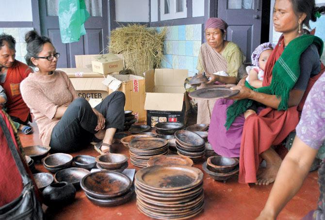 Rida Gatphoh (left) with local Khasi women pack handmade black clay tableware created for the label, Dak_ti Crafts