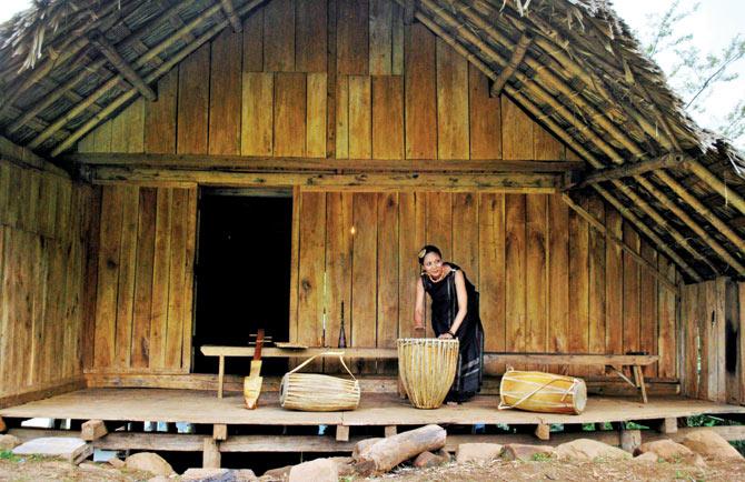 Rida Gatphoh with handcrafted folk instruments outside the Sieng Riti Institute for traditional folk music in Wahkhen, a village in Meghalaya