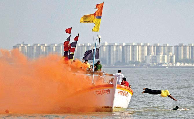 Firefighters carry out a pre-monsoon rescue mock drill in the Arabian Sea near Marine Drive. Pic/PTI