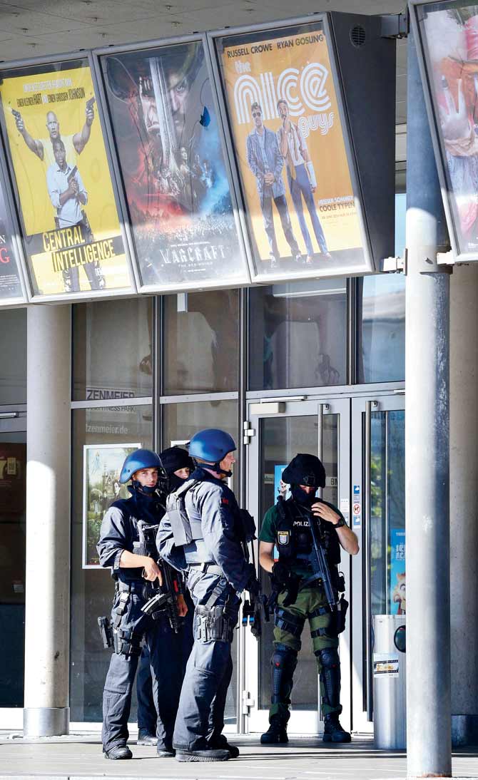 Policemen in front of the cinema where an armed man barricaded himself in Viernheim, Germany yesterday. Pic/AFP