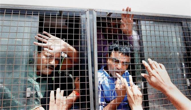 Gulberg society massacre convicts being taken away from the SIT court in Ahmedabad. Pics/PTI
