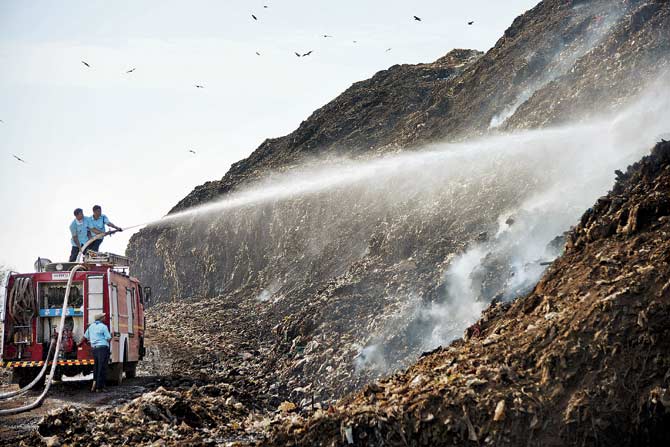 The civic body has hired a contractor to spray water on the garbage in a bid to prevent the fires. File pic