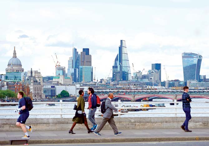 The skyline of buildings in London, seen from Waterloo Bridge as pedestrians walk by in central London. Pic/AFP