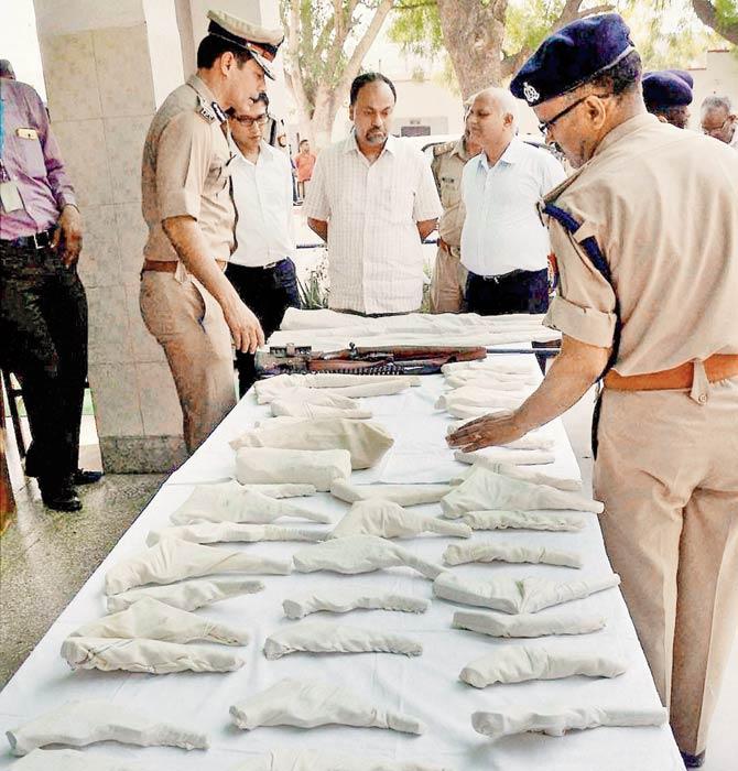 Police display the arms recovered from Jawarhar Bagh