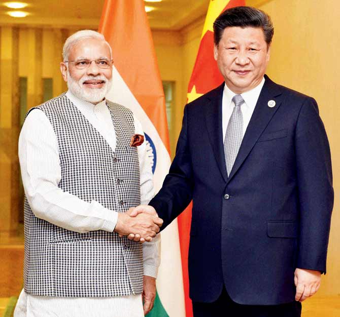 Yes or no: Prime Minister Narendra Modi and Chinese President Xi Jinping meet on the sidelines of the SCO summit in Tashkent. Pics/PTI
