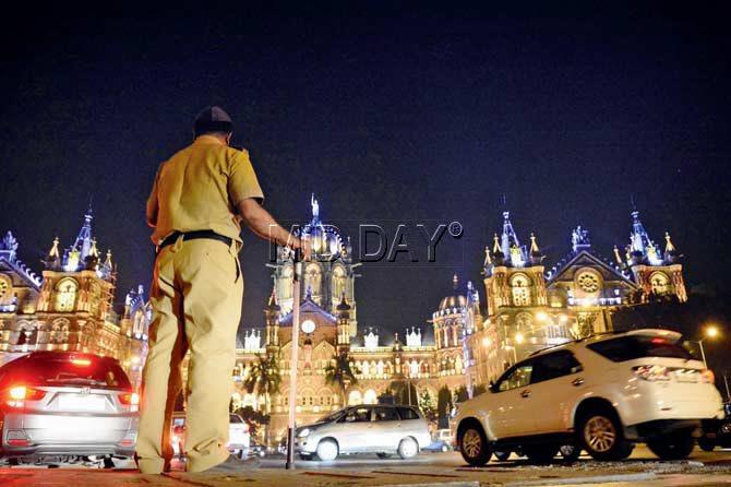 A police constable watches over a lit CST. Pic/Bipin Kokate