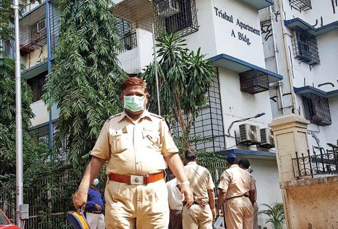 Cops step out of Trishul Apartments in Chembur